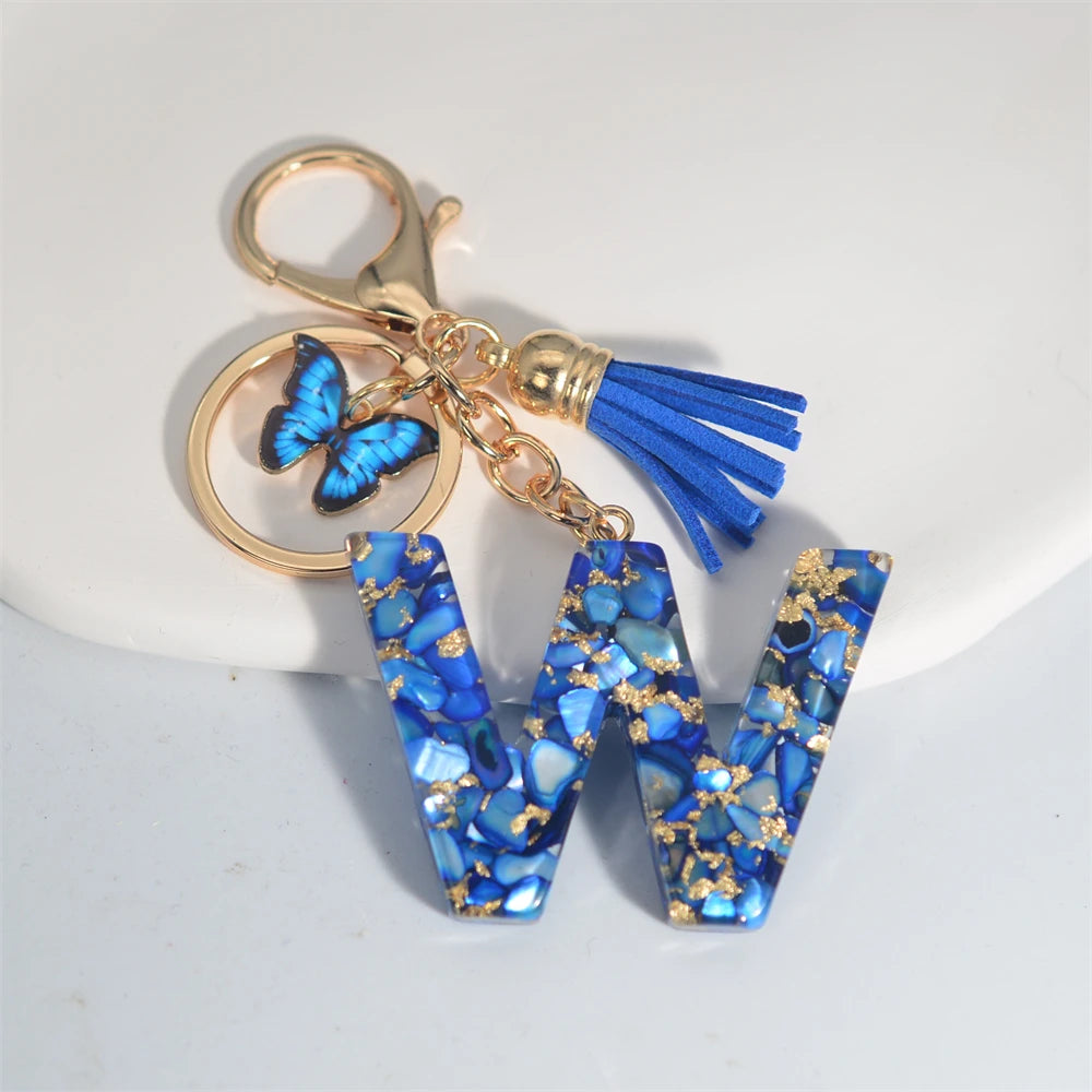 Exquisito llavero de resina de piedra esmaltada azul de A a Z, 26 iniciales, colgante de borla de mariposa, llavero para mujeres y hombres, llavero de coche, regalo