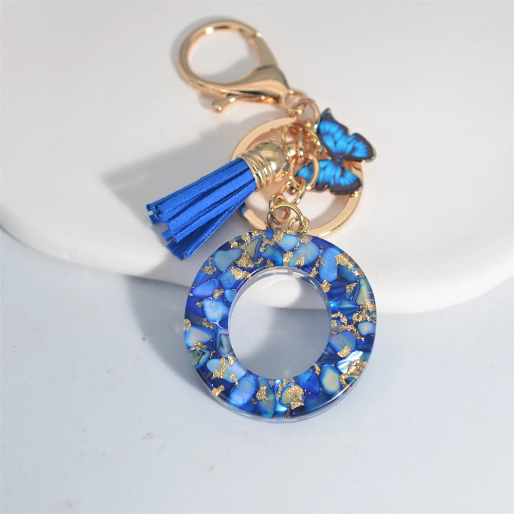 Exquisito llavero de resina de piedra esmaltada azul de A a Z, 26 iniciales, colgante de borla de mariposa, llavero para mujeres y hombres, llavero de coche, regalo