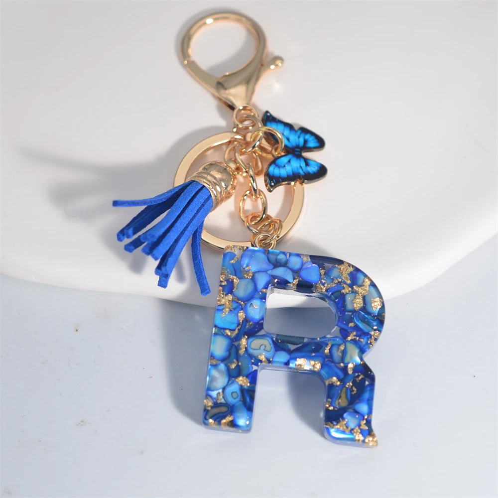 Exquisito llavero de resina de piedra esmaltada azul de A a Z, 26 iniciales, colgante de borla de mariposa, llavero para mujeres y hombres, llavero de coche, regalo