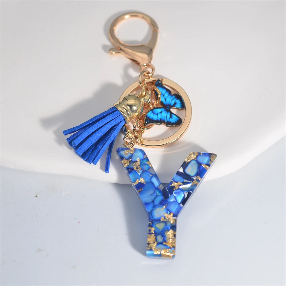 Exquisito llavero de resina de piedra esmaltada azul de A a Z, 26 iniciales, colgante de borla de mariposa, llavero para mujeres y hombres, llavero de coche, regalo