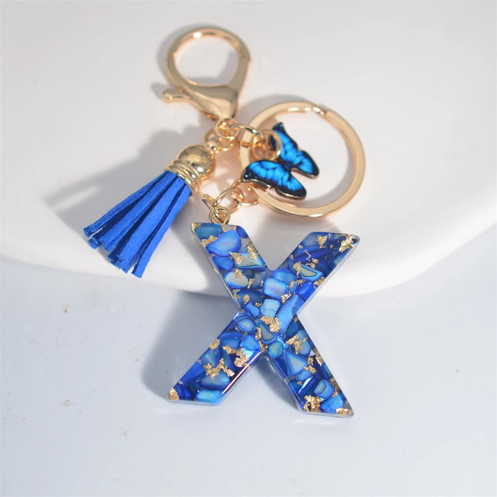Exquisito llavero de resina de piedra esmaltada azul de A a Z, 26 iniciales, colgante de borla de mariposa, llavero para mujeres y hombres, llavero de coche, regalo