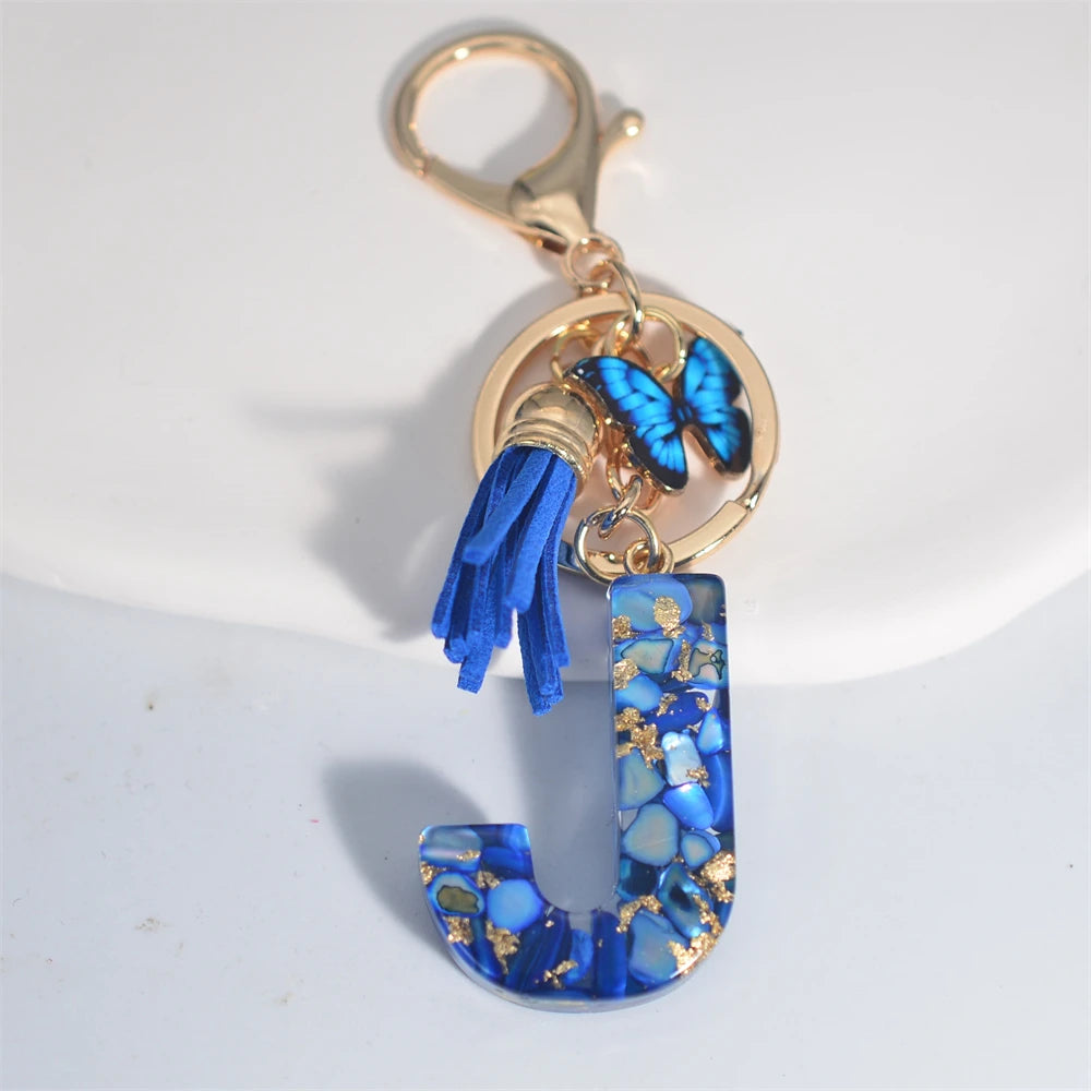 Exquisito llavero de resina de piedra esmaltada azul de A a Z, 26 iniciales, colgante de borla de mariposa, llavero para mujeres y hombres, llavero de coche, regalo