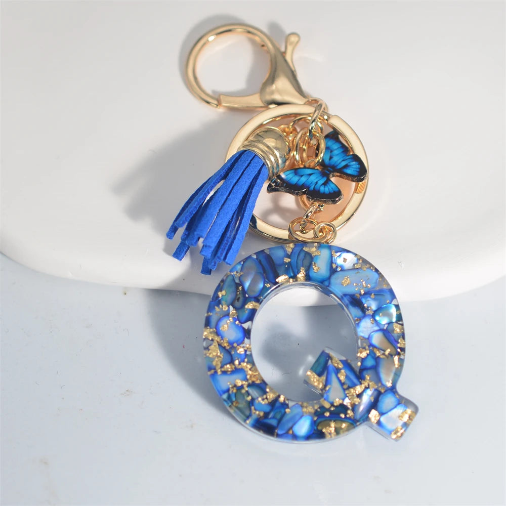 Exquisito llavero de resina de piedra esmaltada azul de A a Z, 26 iniciales, colgante de borla de mariposa, llavero para mujeres y hombres, llavero de coche, regalo