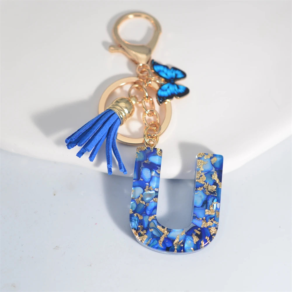Exquisito llavero de resina de piedra esmaltada azul de A a Z, 26 iniciales, colgante de borla de mariposa, llavero para mujeres y hombres, llavero de coche, regalo