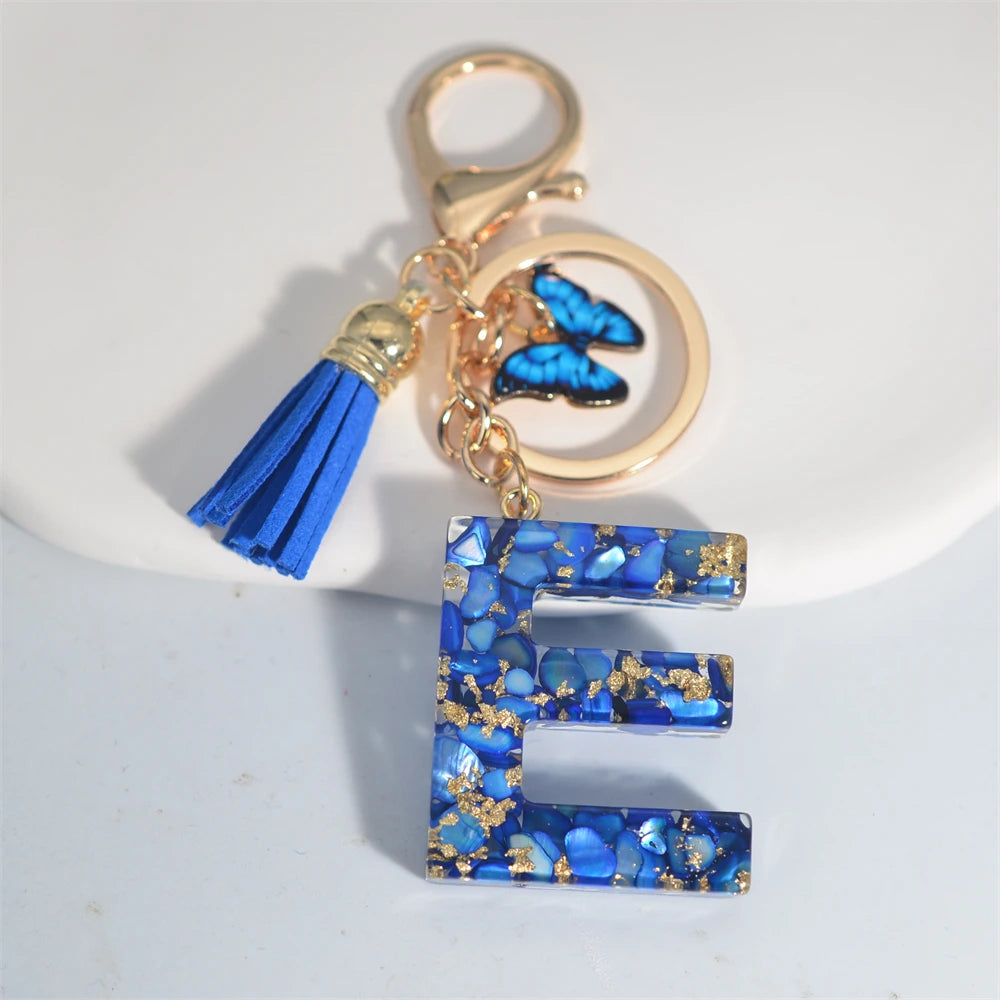 Exquisito llavero de resina de piedra esmaltada azul de A a Z, 26 iniciales, colgante de borla de mariposa, llavero para mujeres y hombres, llavero de coche, regalo