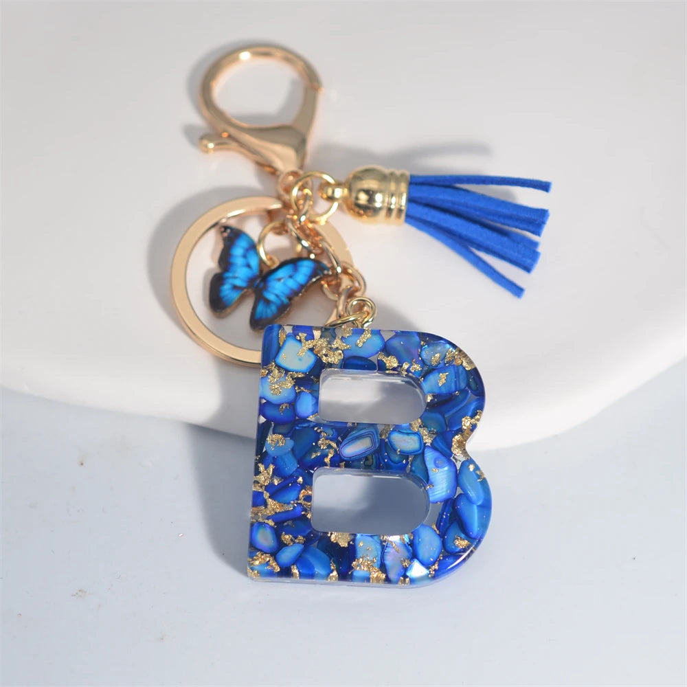 Exquisito llavero de resina de piedra esmaltada azul de A a Z, 26 iniciales, colgante de borla de mariposa, llavero para mujeres y hombres, llavero de coche, regalo