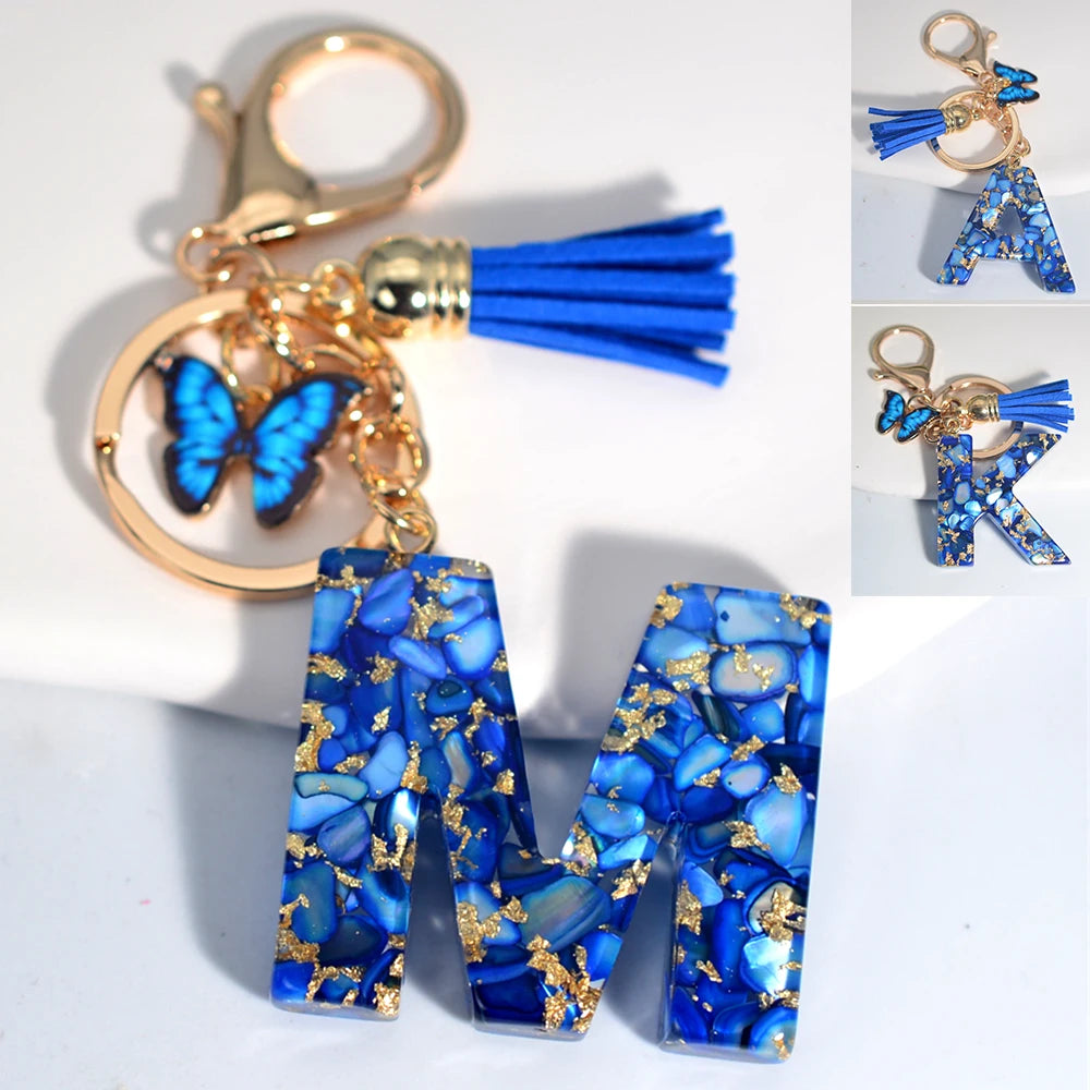 Exquisito llavero de resina de piedra esmaltada azul de A a Z, 26 iniciales, colgante de borla de mariposa, llavero para mujeres y hombres, llavero de coche, regalo