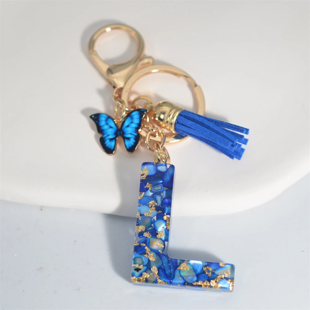 Exquisito llavero de resina de piedra esmaltada azul de A a Z, 26 iniciales, colgante de borla de mariposa, llavero para mujeres y hombres, llavero de coche, regalo